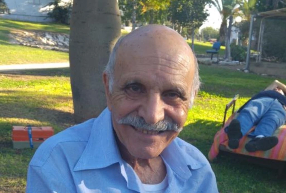 Portrait of a smiling older man with a mustache.