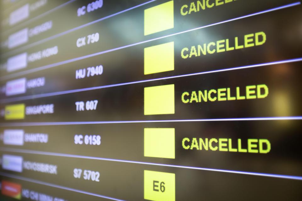 2BM0D0P Flights cancelled and delayed on airport departure board due to covid-19 pandemic. Coronavirus causing disruption in air transport with airlines cance