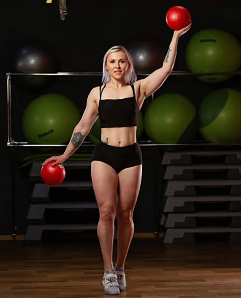 Ukrainian powerlifting champion Yulia Lemeshchenko holding medicine balls.