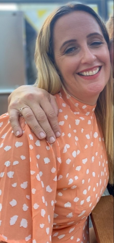 Woman in peach dress with white spots.