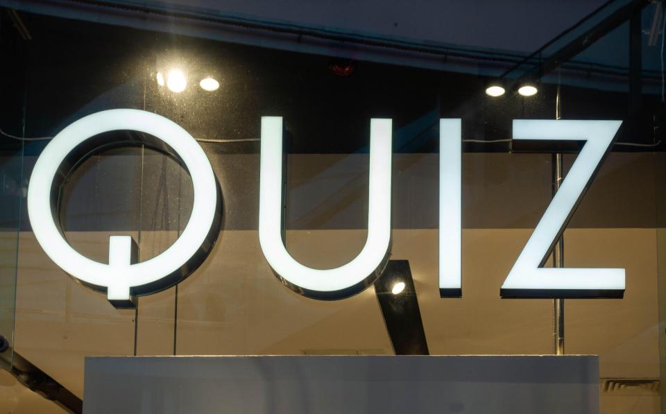 Quiz clothing store sign.