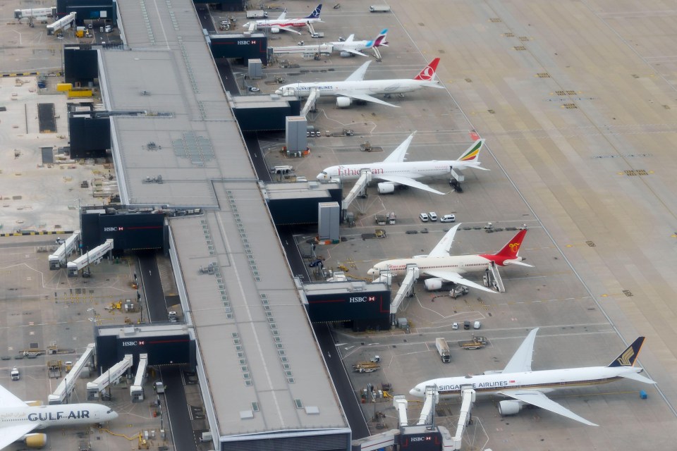 Aerial view of Heathrow Airport Terminal 2 gates with several airplanes.