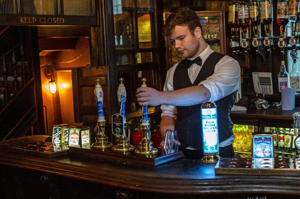 Bartender pouring beer at a pub.