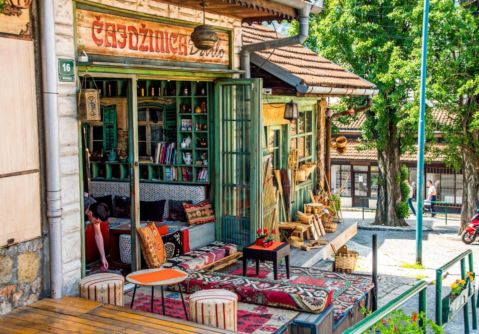 A Sarajevo cafe with colorful rugs and pillows.