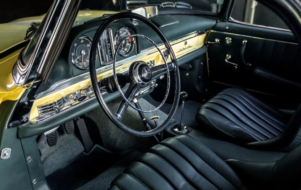 Interior view of a yellow Mercedes-Benz 300 SL Roadster.