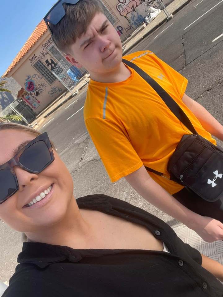 A woman and a boy posing for a selfie.