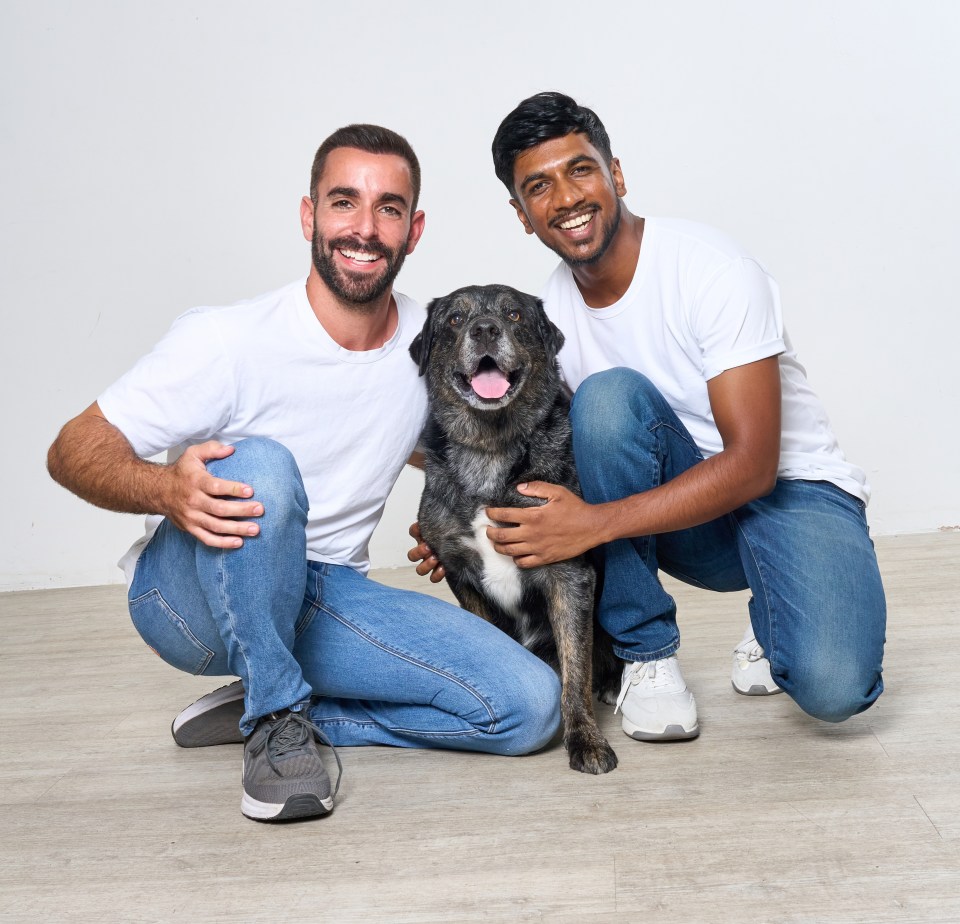 Two men and a dog sitting on the floor.