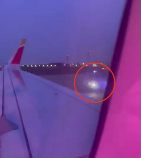 Video grab showing emergency responders detaining a passenger on the tarmac after he opened an emergency exit and jumped from a plane.