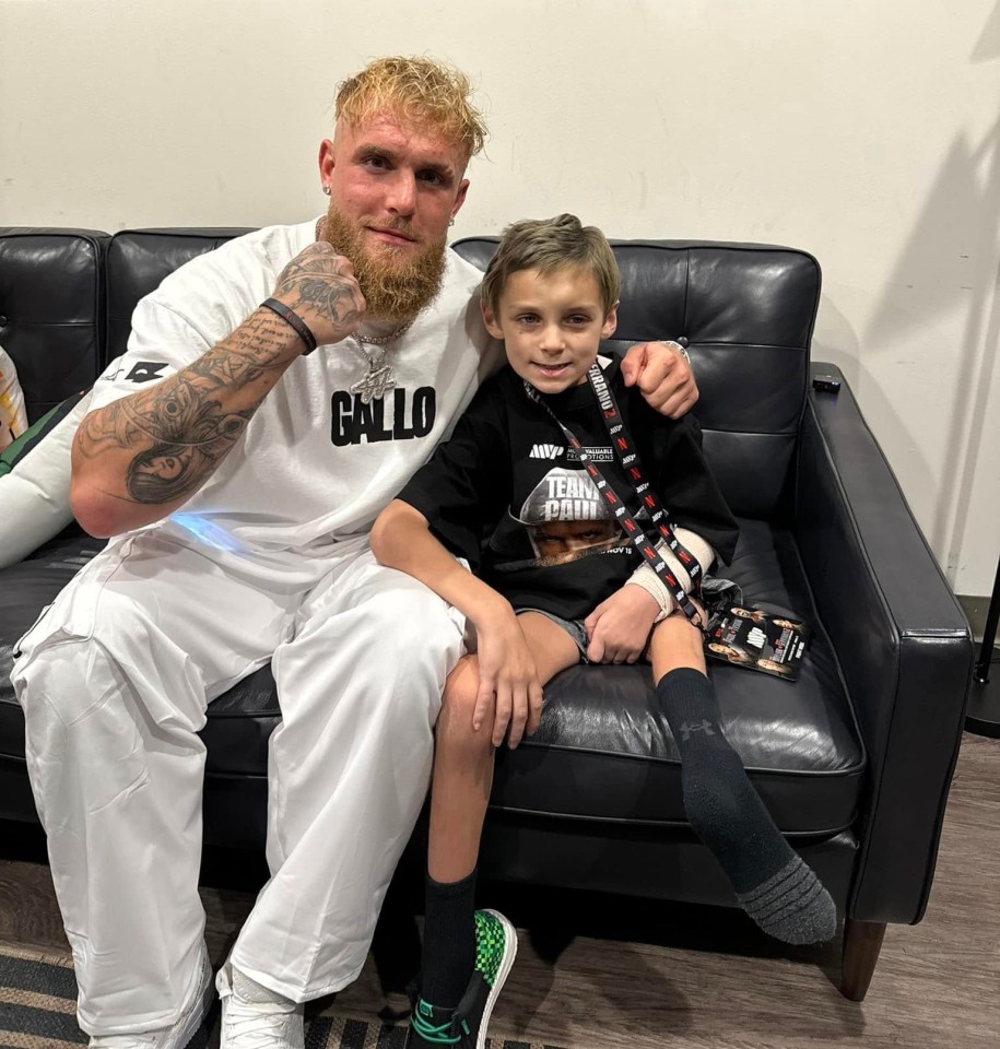 A man and a young boy sitting on a couch.