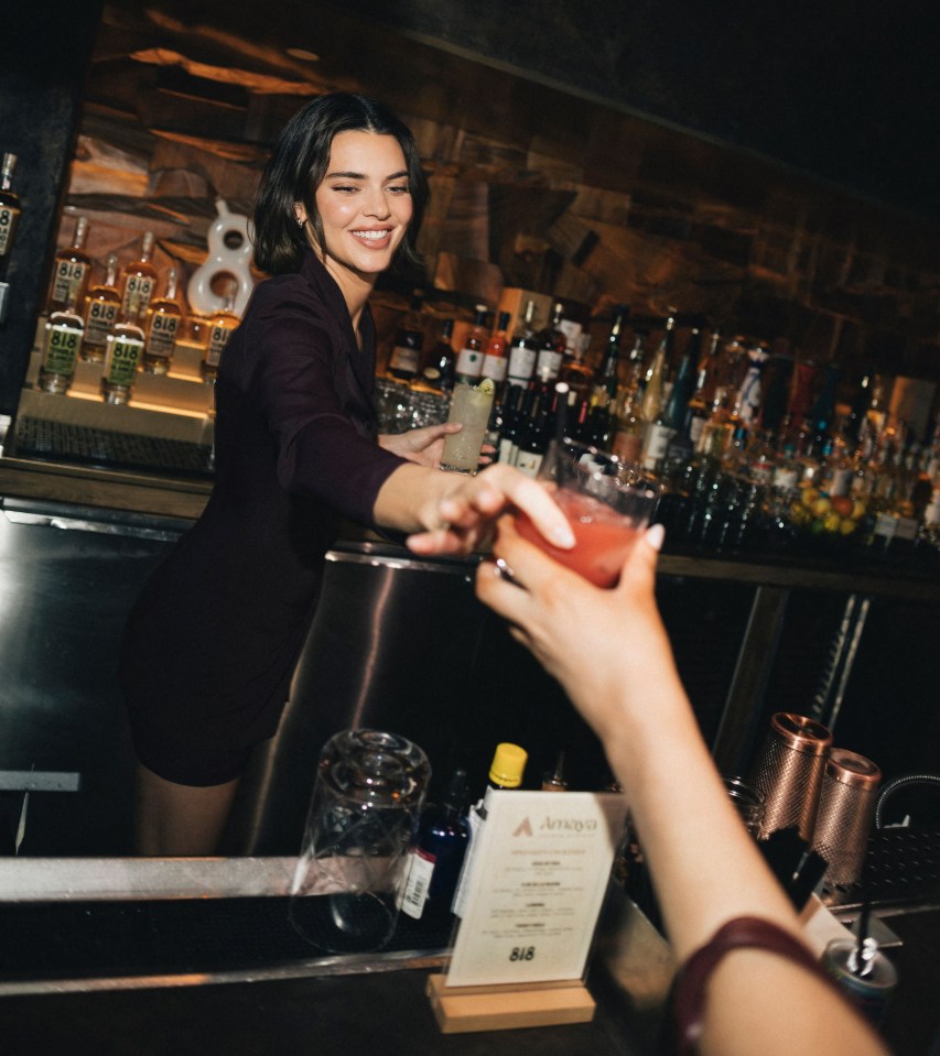 Kendall Jenner serving 818 Tequila cocktails at a bar.