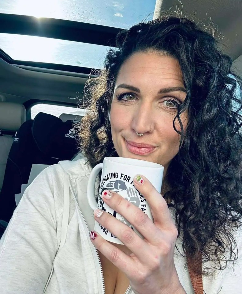 Woman in car holding mug that says "Advocating for Families."