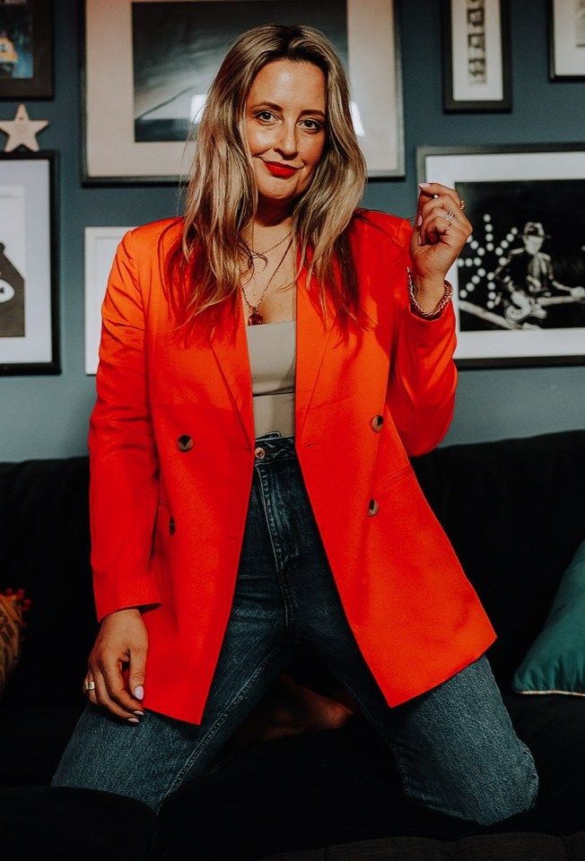 Woman sitting on a beige couch.