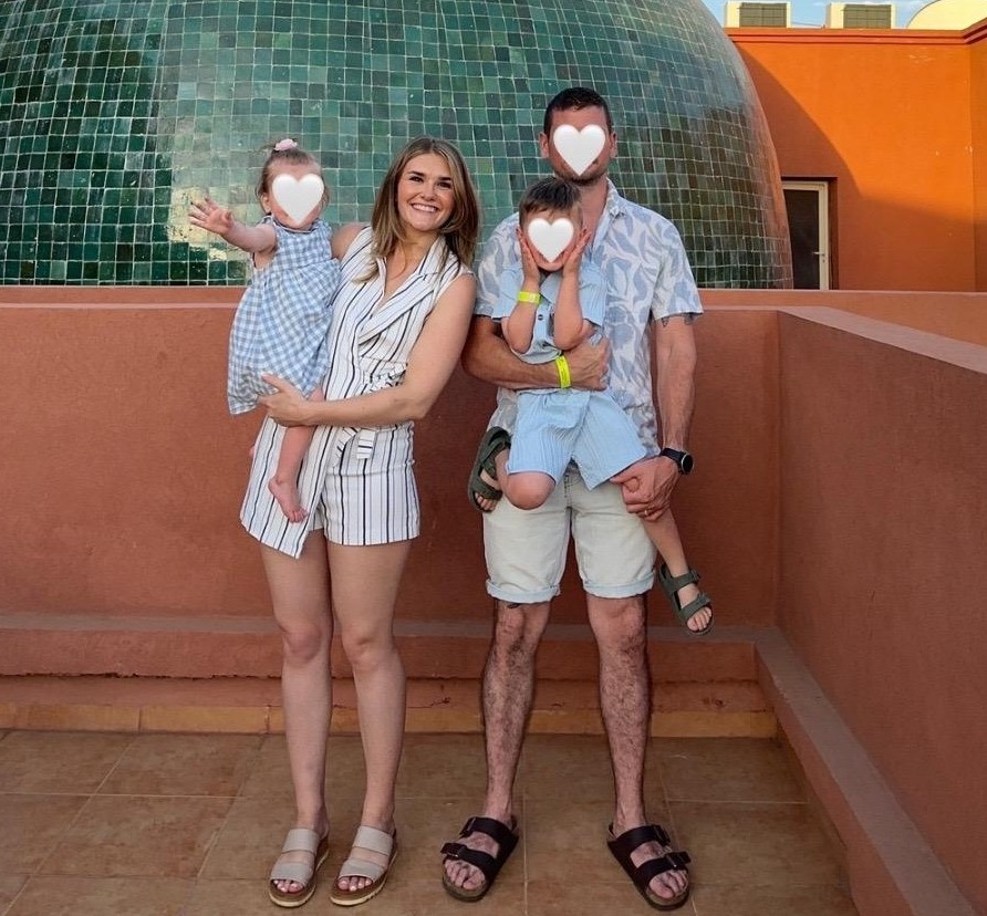 Family on holiday in front of a large green dome.