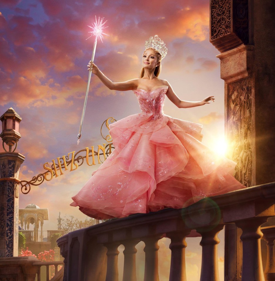 Ariana Grande as Glinda in Wicked, holding a wand.