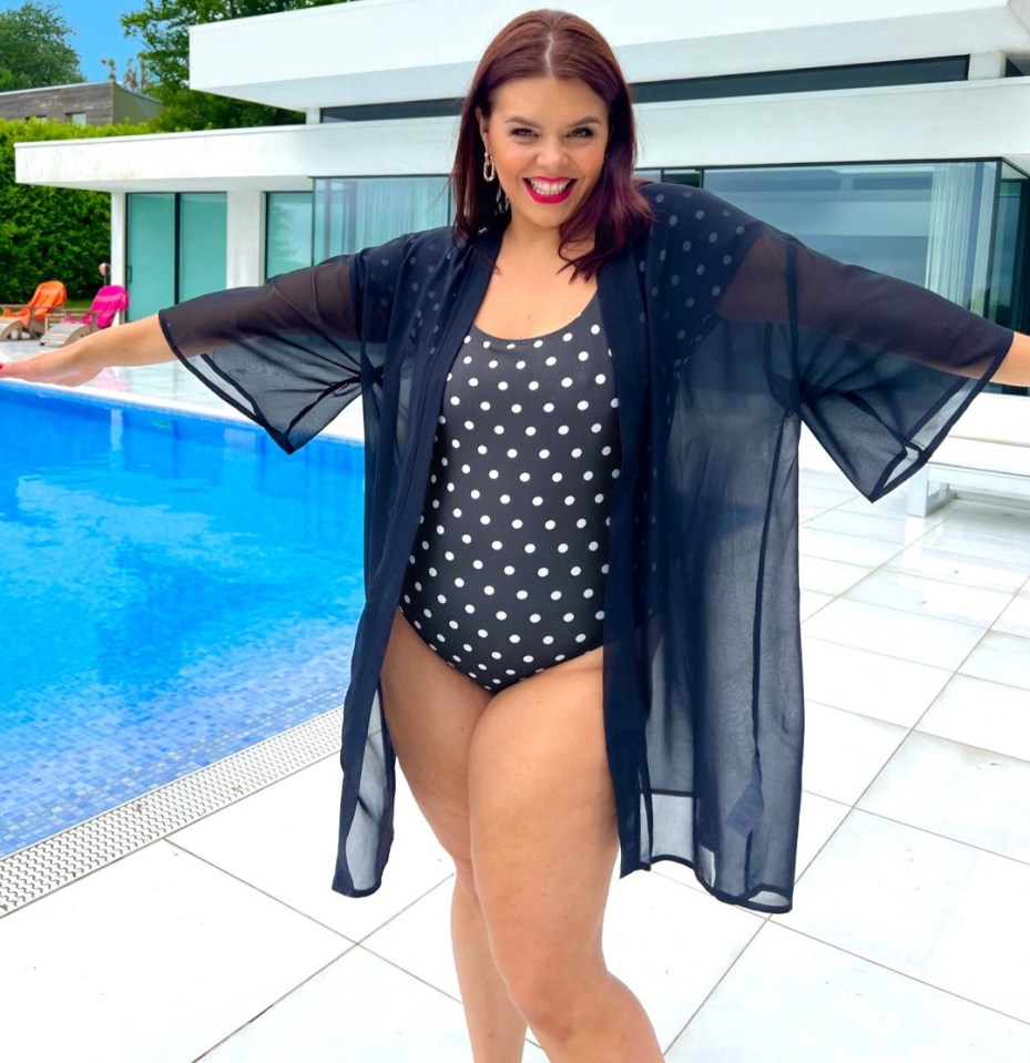 Woman in polka dot swimsuit and sheer coverup by pool.