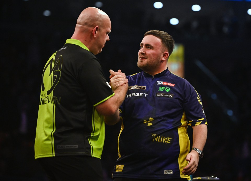 Michael van Gerwen and Luke Littler shaking hands after a darts match.