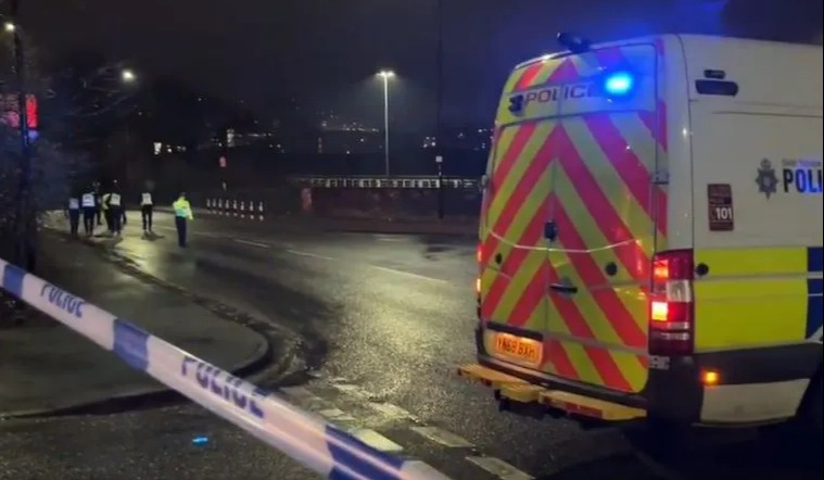 Evacuated residents and police at night.