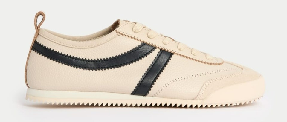 Beige leather trainers with black stripes.