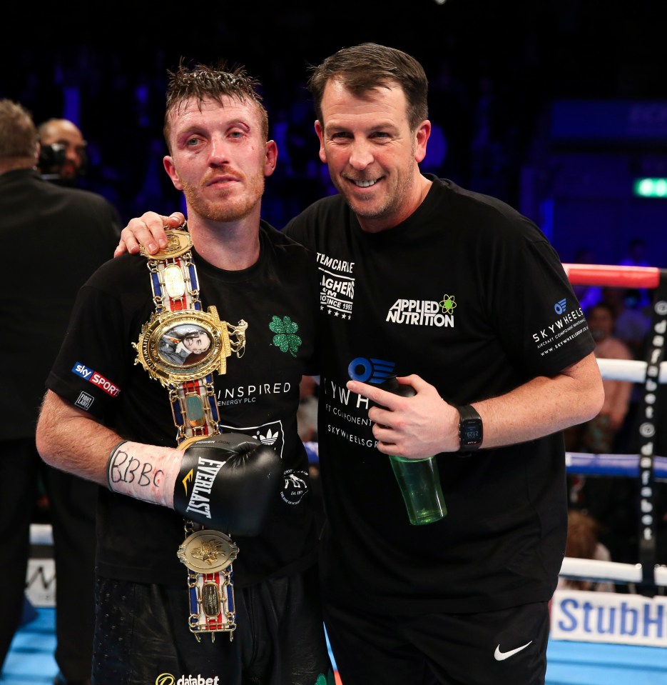 Boxer with his trainer and championship belt.