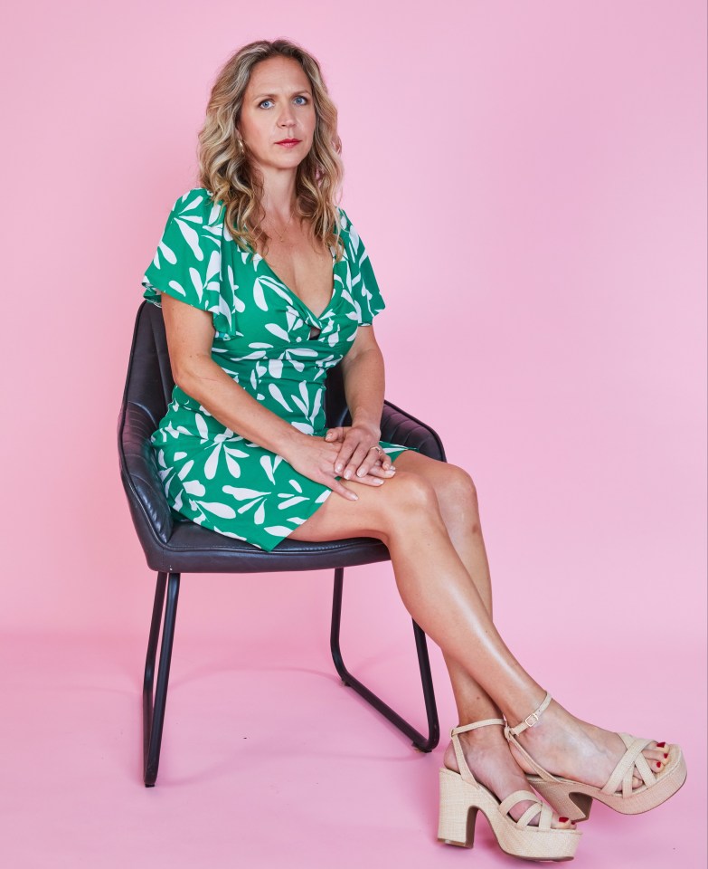 Woman in green dress sitting on a chair.