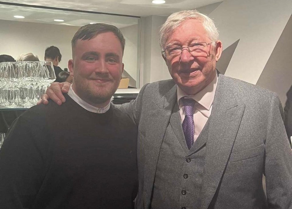 Photo of Sir Alex Ferguson with a young man.