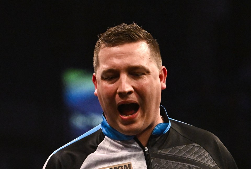 Chris Dobey celebrating during a darts match.