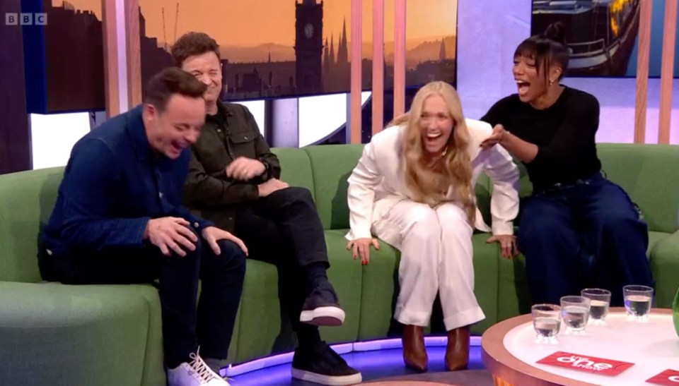 Screenshot of four people laughing on a talk show.