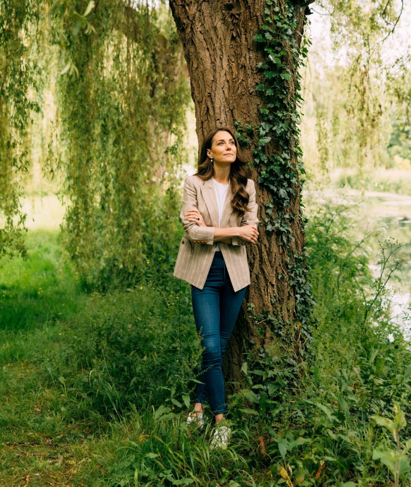 Photo of Catherine, Princess of Wales, leaning against a tree.