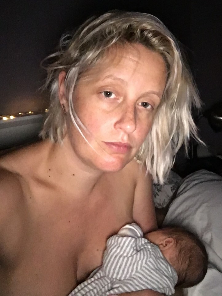 Woman breastfeeding a baby in bed at night.