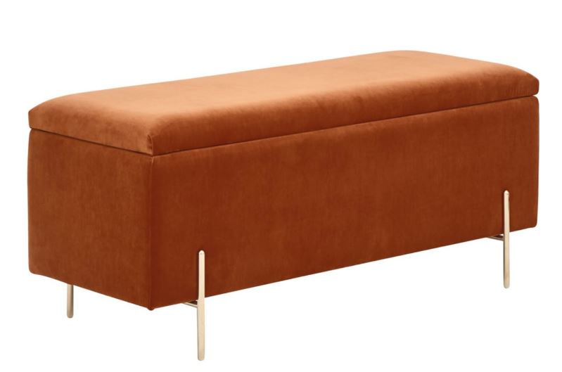 Orange velvet storage bench with gold legs.