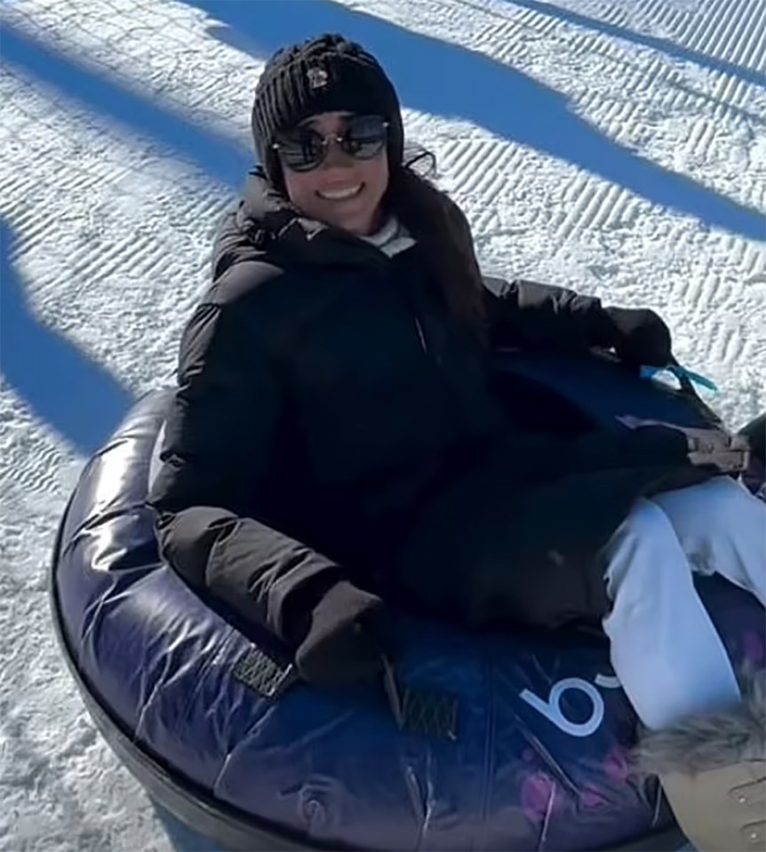 Woman snow tubing.