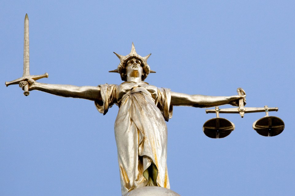 Statue of Justice holding scales and a sword.