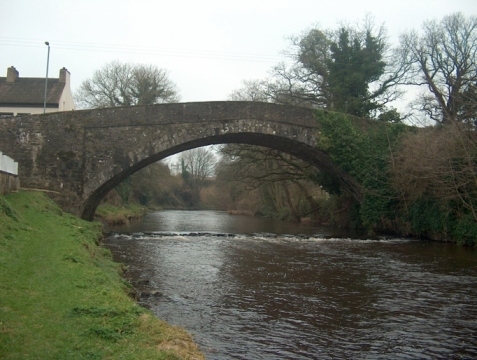 Stone arch bridge over a river.