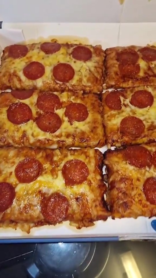 Six rectangular pepperoni pizzas in a box.