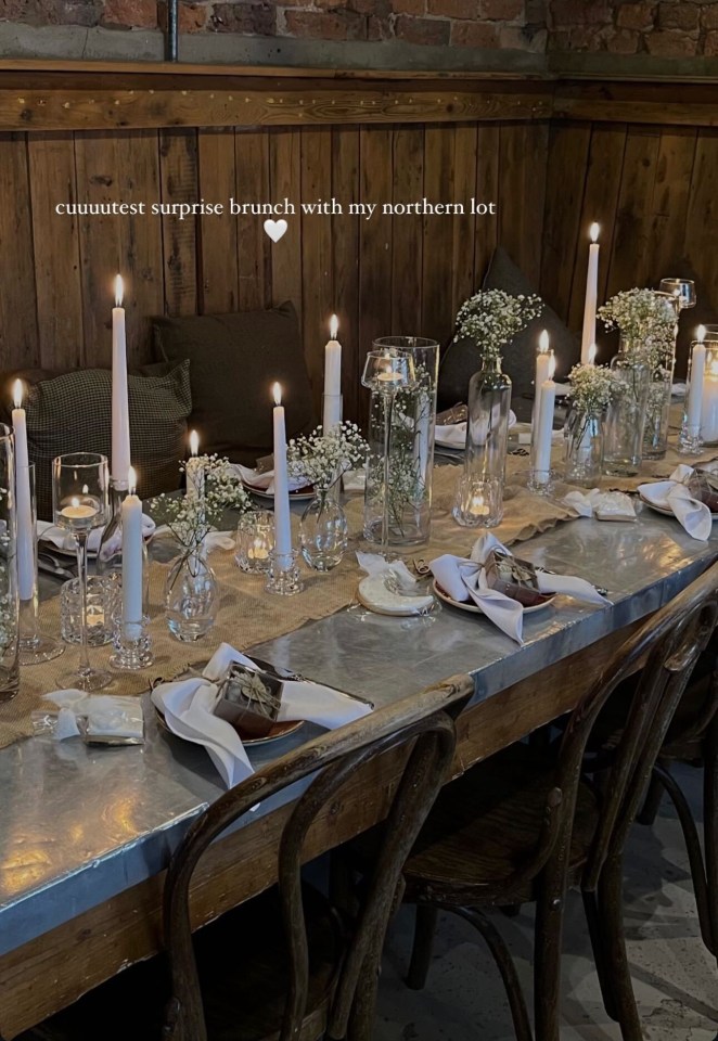 Table set for brunch with candles and flowers.