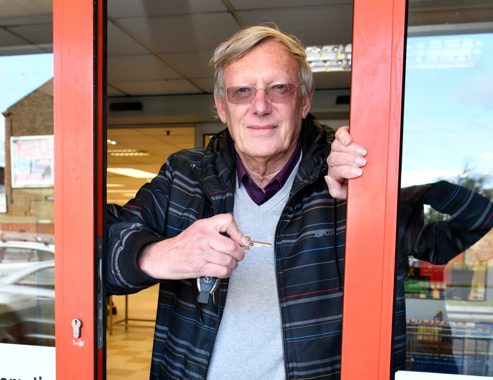 Man holding keys, closing shop door.