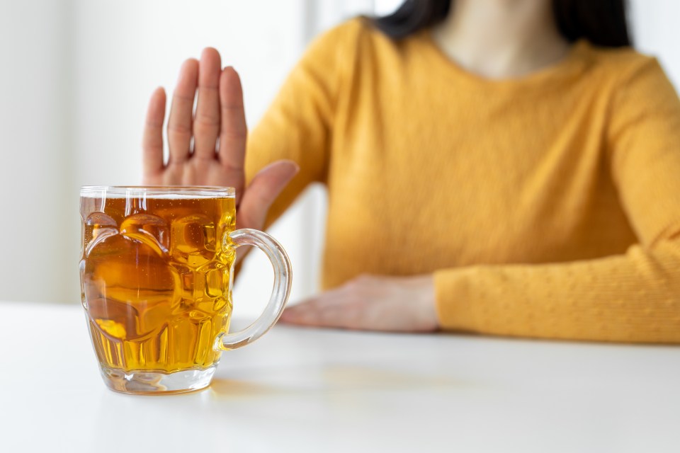 Woman refusing a beer.