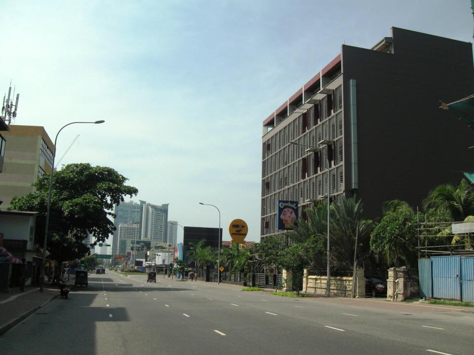 Kollupitiya street scene with buildings and vehicles.