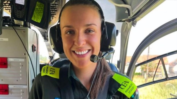 Smiling paramedic student in helicopter.