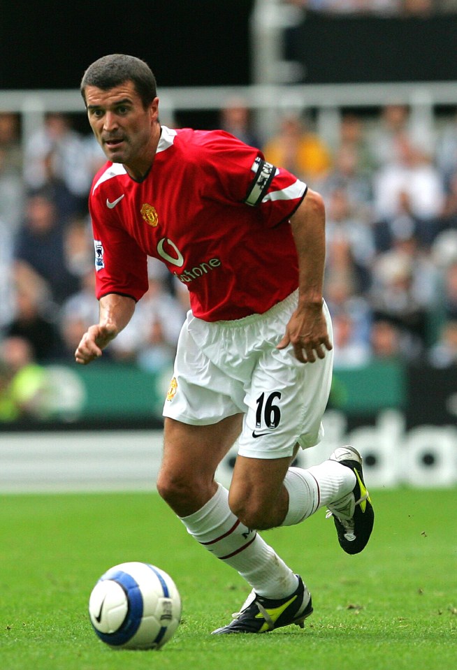 Roy Keane, Manchester United player, running with the soccer ball.