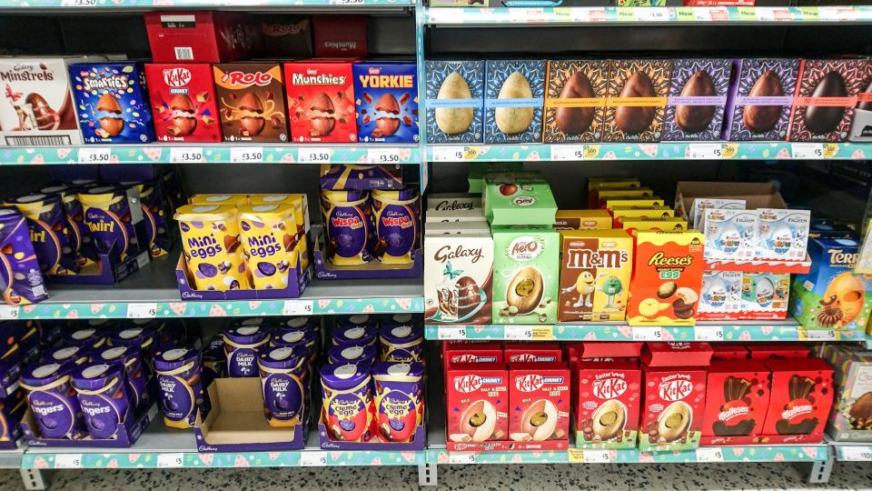 Supermarket shelf stocked with various Easter chocolate eggs.