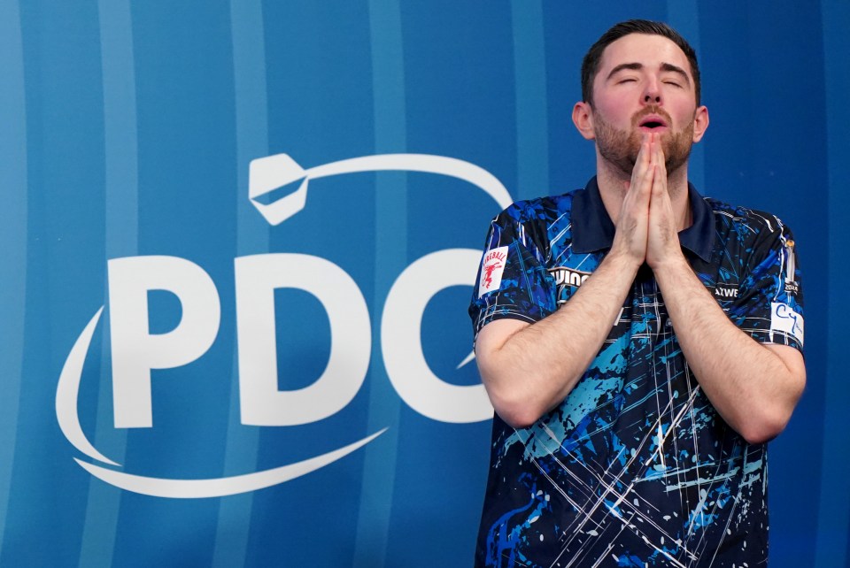 Luke Humphries reacting after winning a darts match.