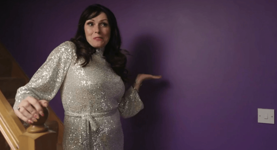 Woman in a silver sequined dress on a staircase.