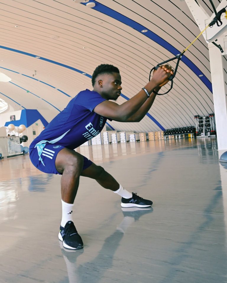 Athlete performing resistance band exercise.