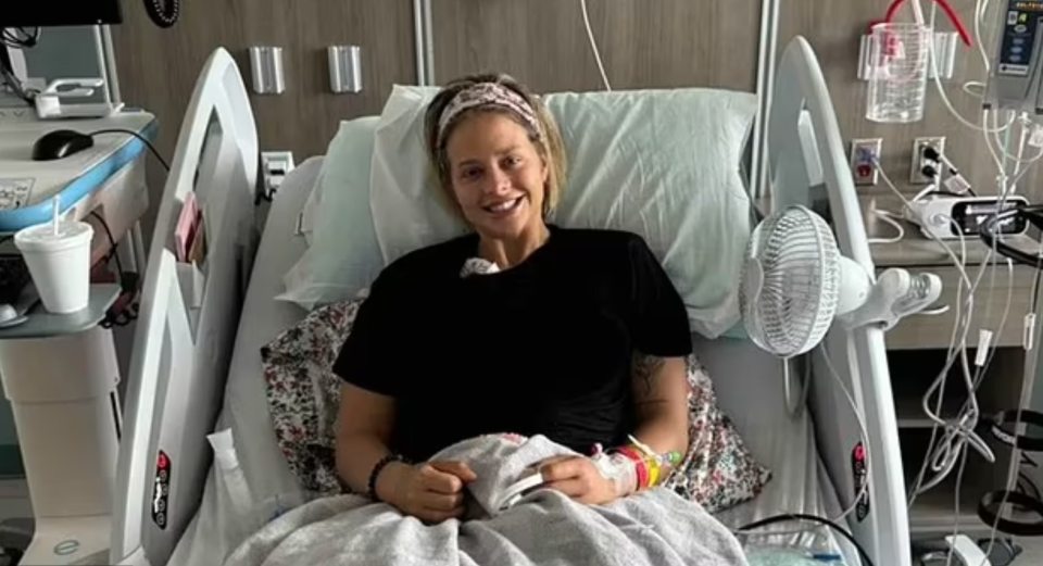 Woman smiling in a hospital bed.