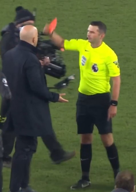 Referee showing a red card to a coach.