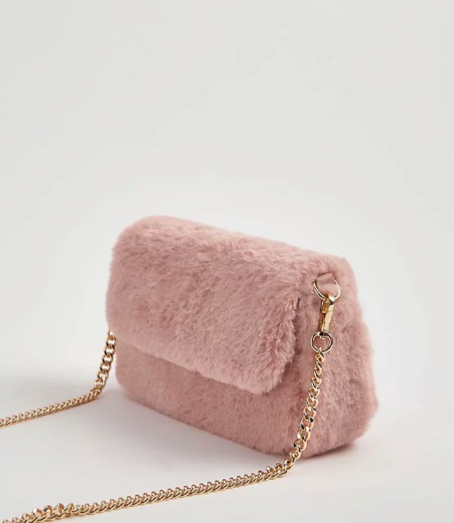 Pink faux fur crossbody bag with gold chain strap.