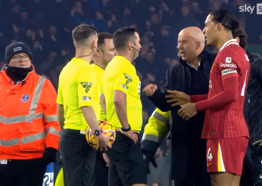 A soccer player arguing with a referee and coach.