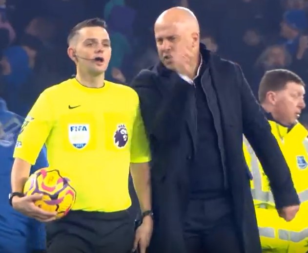 A soccer coach arguing with a referee.