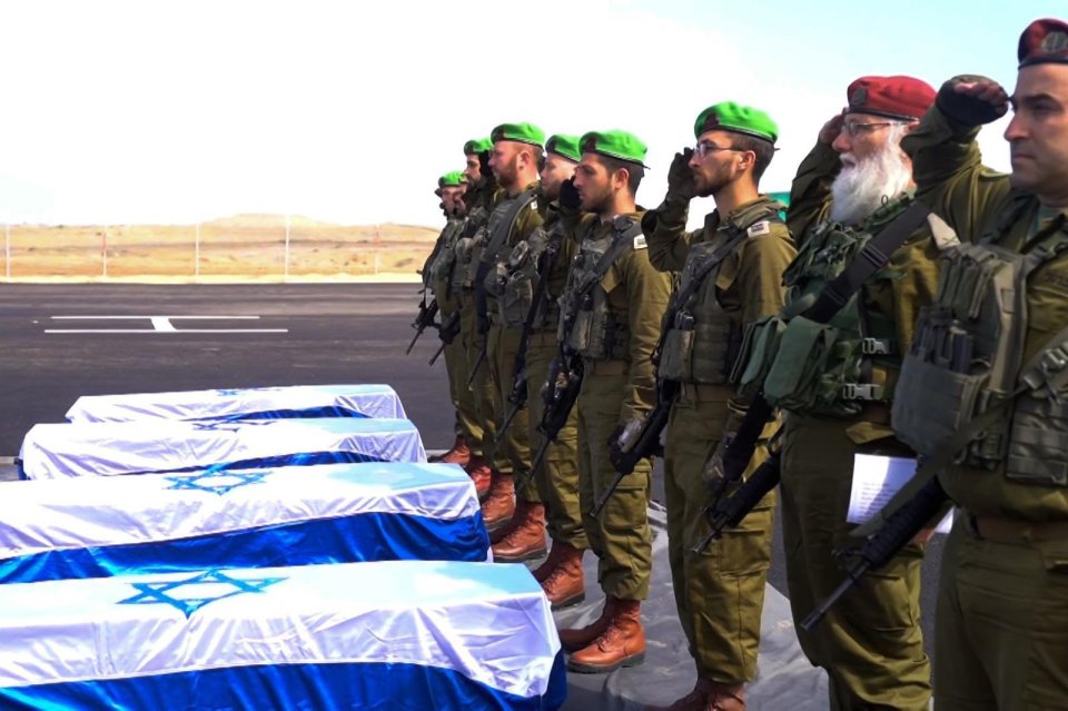 IDF soldiers saluting during a repatriation ceremony for deceased hostages.